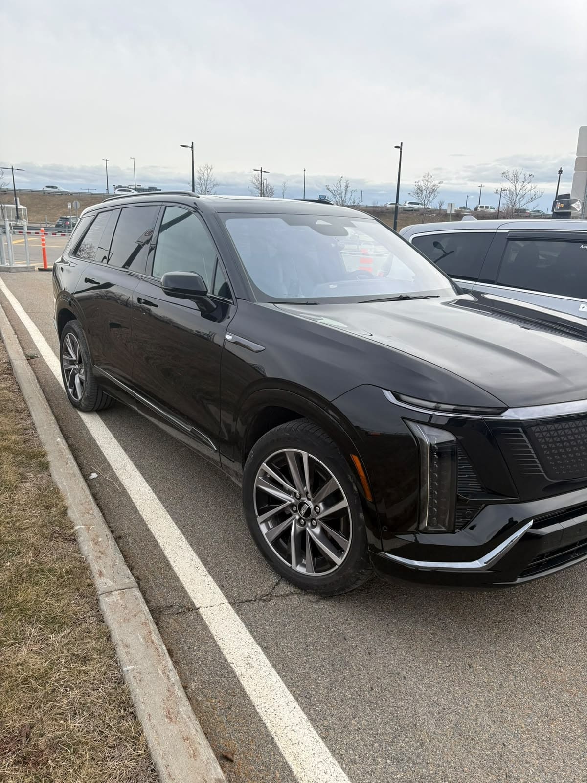Black Cadillac Escalade IQ electric SUV, part of the US Limo and Taxi fleet